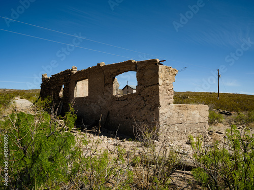 A church steeple seen through the remains of a building in the ghost town of  Lake Valley, New Mexico photo