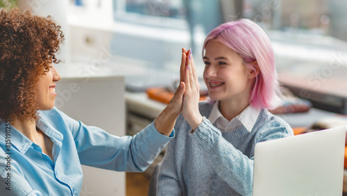 Businesswoman CEO giving a high five to a colleague in meeting sitting in a modern office