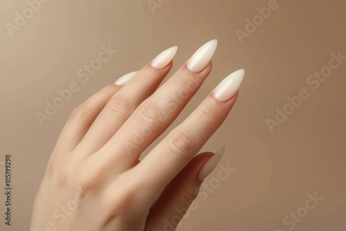 Beautiful woman's hand with wellgroomed nails on beige background, closeup, copy space concept for nail salon and beauty studio banner design photo