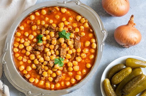 Delicious traditional turkish chickpea dish with meat in metal plate, turkish meal