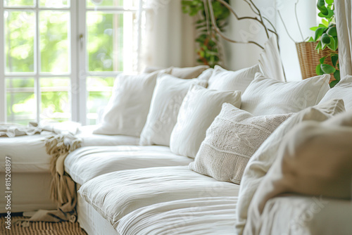 Close up of white sofas against window. Farmhouse country boho interior design of modern living room home.