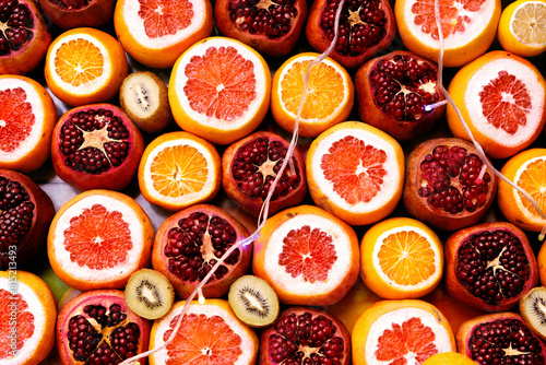 Grapefruit, pomegranate, kiwi and orange fruit texture background