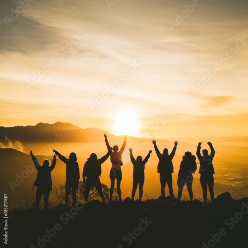 Silhouette of group happy business team making high hands over head in beautiful sunset sky evening time for business success and teamwork concept in company. International Friendship Day.
