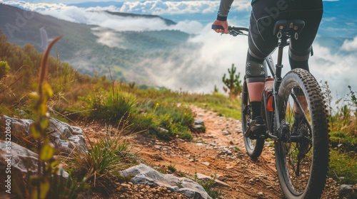 Mountain Biker on Rugged Trail with Scenic Cloudy View