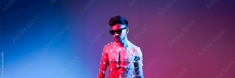 young man model in studio with blue and red light young man model in studio with blue and red light