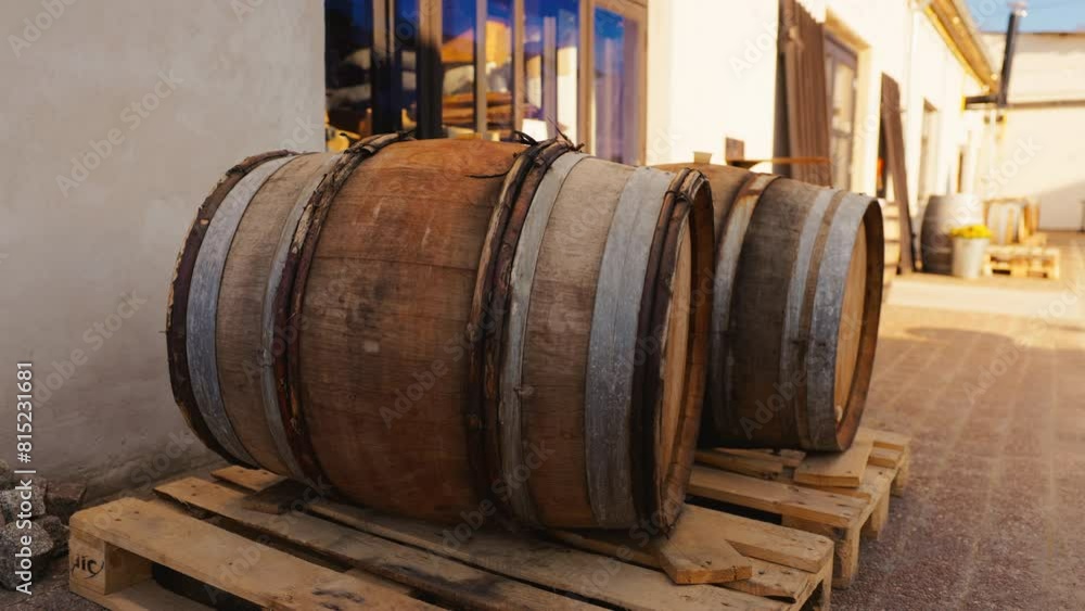 Three wooden barrels stacked on pallet, winery kegs Three wooden barrels stacked on pallet, winery kegs