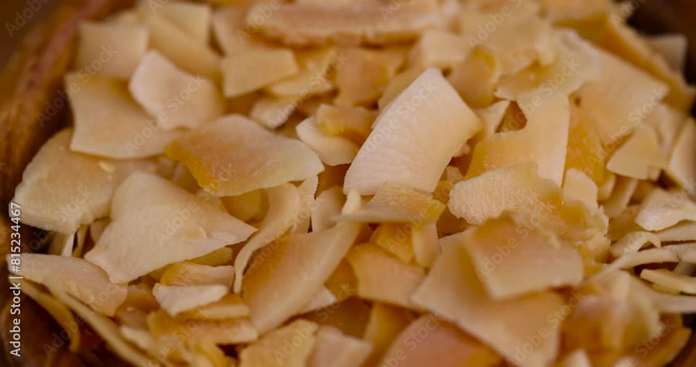 thin coconut flakes fried in sugar syrup , sweet orange and yellow coconut flakes fried in sugar thin coconut flakes fried in sugar syrup , sweet orange and yellow coconut flakes fried in sugar