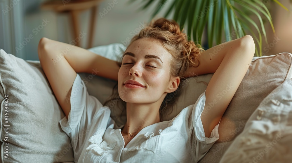woman sitting on sofa and embracing her belly. Portrait of woman resting at her cozy home woman sitting on sofa and embracing her belly. Portrait of woman resting at her cozy home