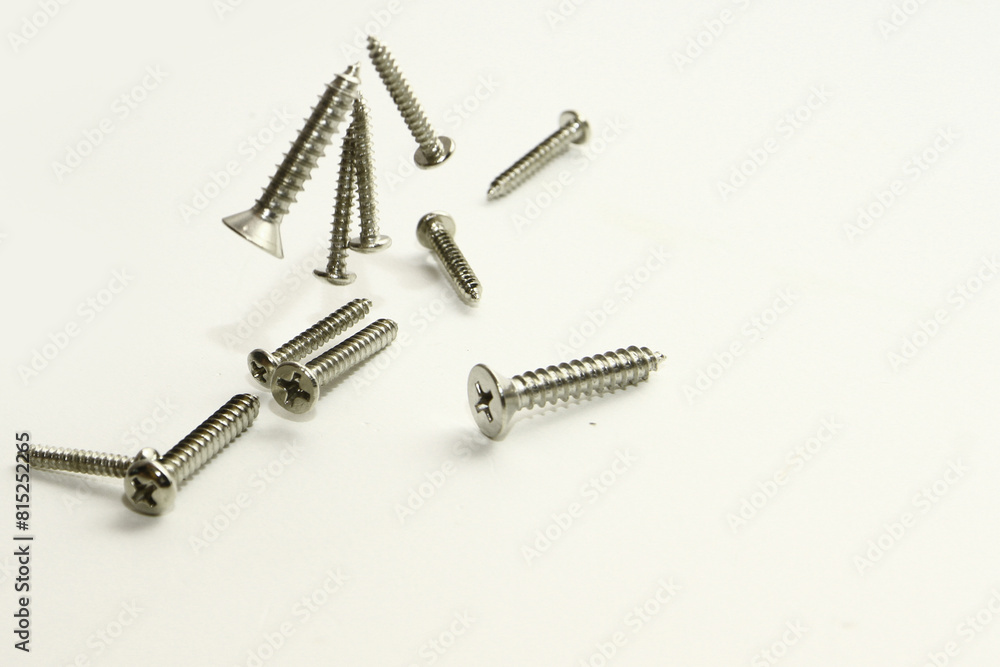 Stainless steel flat head sharp end screw on white background Stainless steel flat head sharp end screw on white background