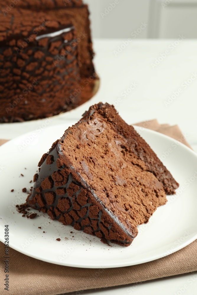 Piece of delicious chocolate truffle cake on table, closeup Piece of delicious chocolate truffle cake on table, closeup