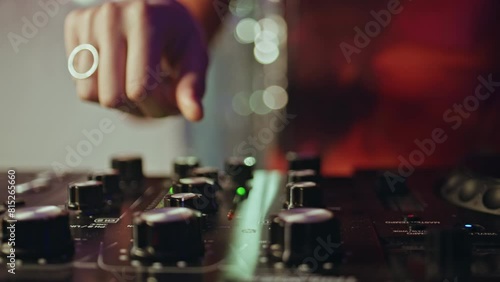 DJ hand using mixer expertly controlling nightclub rhythm closeup. Woman mixing 