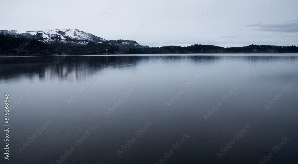 Alpine landscape. Long exposure view of the serene lake, forest and mountains at sunrise. Alpine landscape. Long exposure view of the serene lake, forest and mountains at sunrise.