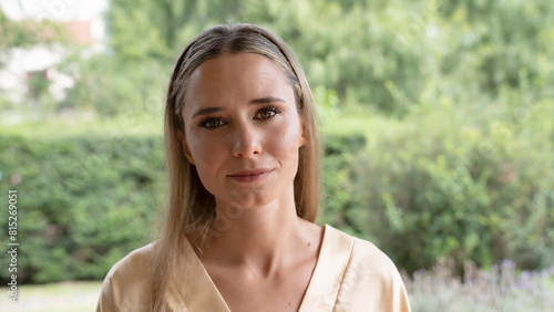 Portrait of a young woman in her 20s with professional make up, looking at camera with a gentle smile, and wearing a silk kimono.