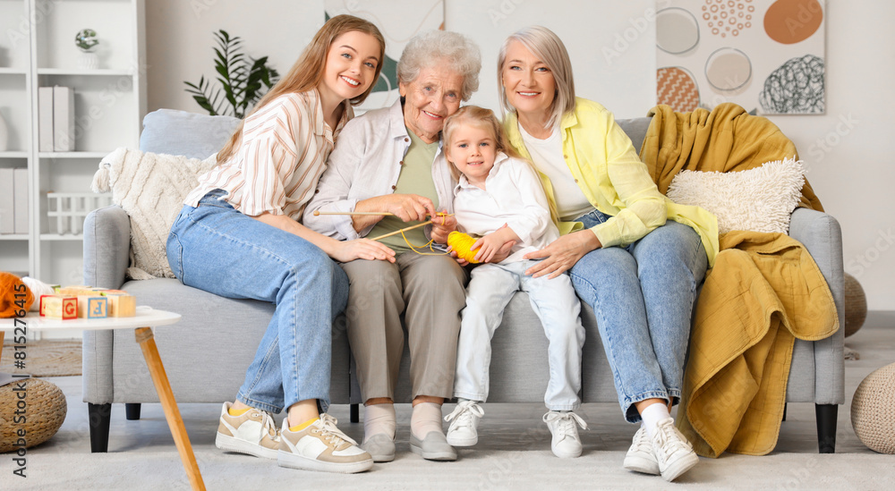 Little girl with her family sitting on sofa at home Little girl with her family sitting on sofa at home