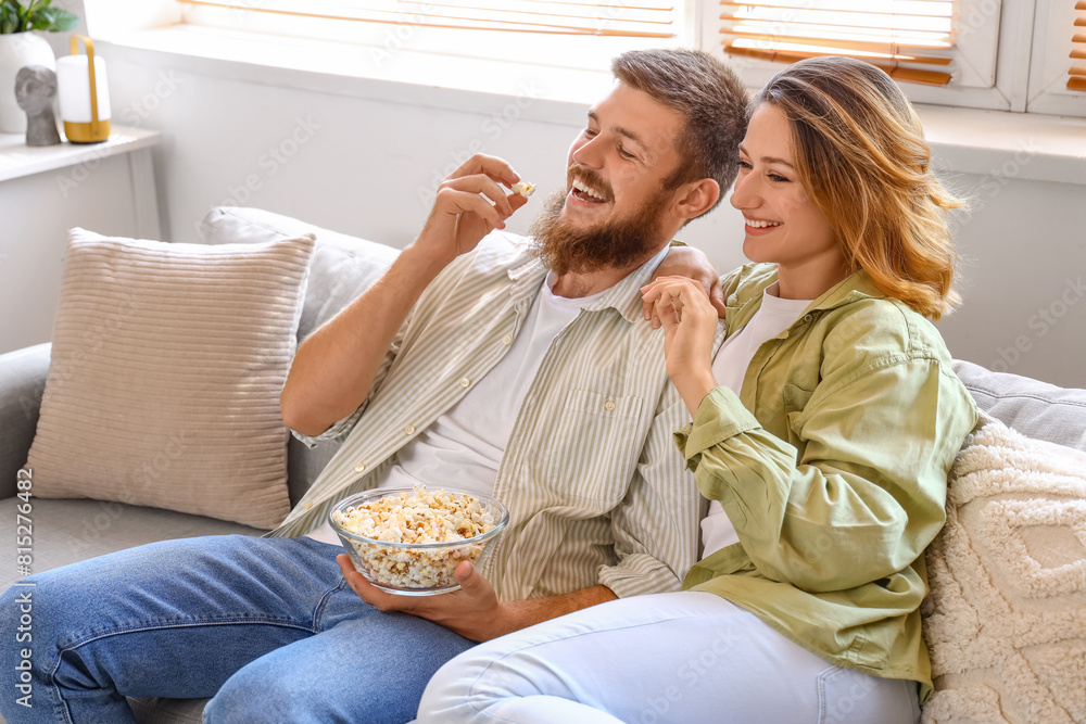 Happy couple in love eating popcorn at home Happy couple in love eating popcorn at home
