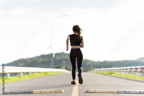 Healthy young female runner stretches her legs before running in the park. Woman exercising for health, jogging outdoors, concept of people and lifestyle, health and well-being. In parks and outdoors