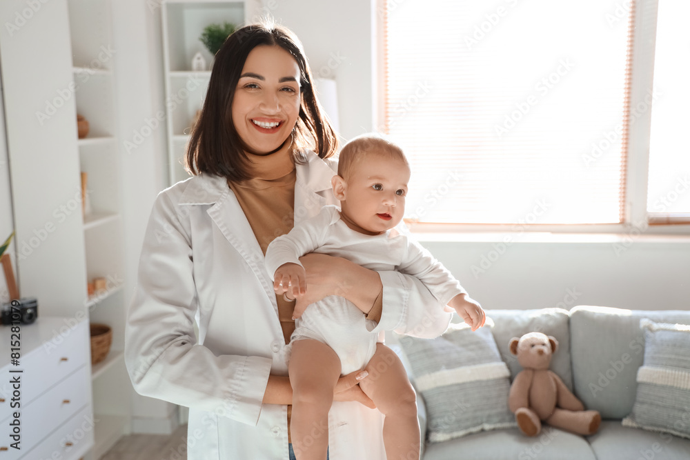 Female pediatrician holding little baby at home Female pediatrician holding little baby at home