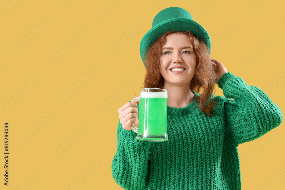 Young redhead woman with beer on yellow background. St. Patrick's Day celebration Young redhead woman with beer on yellow background. St. Patrick's Day celebration