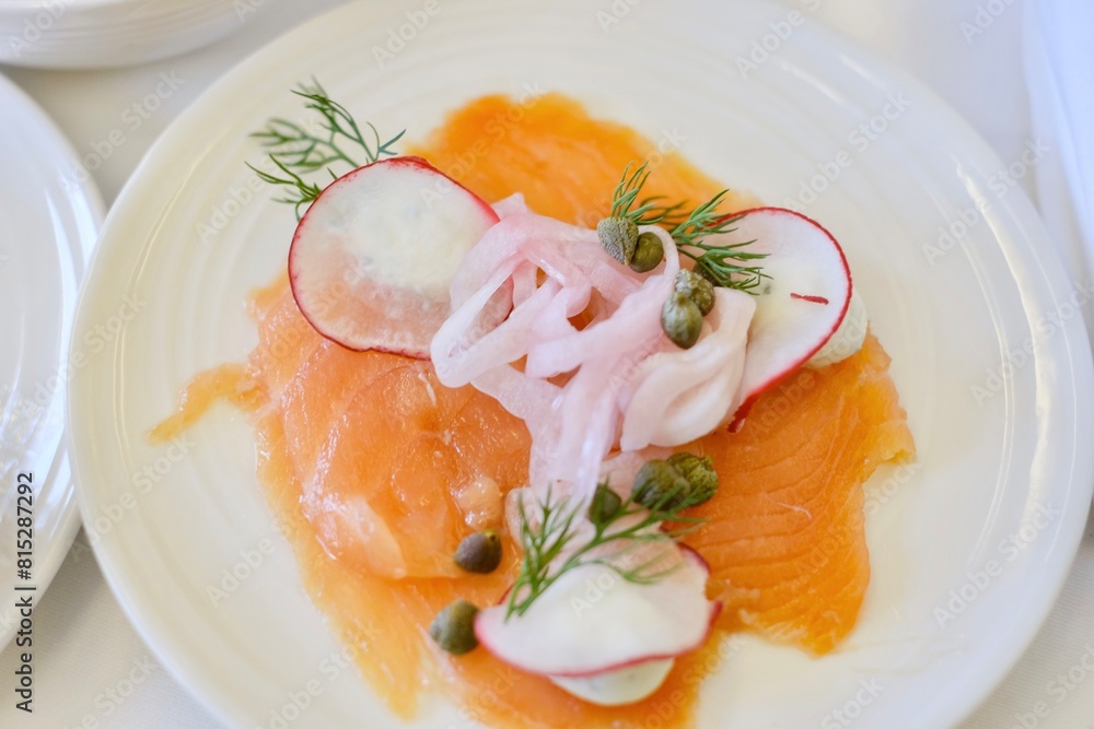 An entree of smoked salmon with herbed cream cheese, red radish, capers, pickled onion on a business class flight from Sydney to Kuala Lumpur