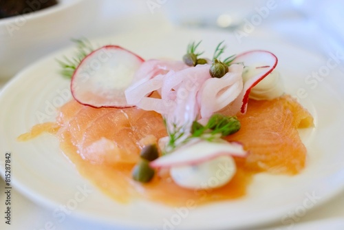 Photography An entree of smoked salmon with herbed cream cheese, red radish, capers, pickled
