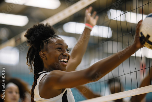 A team of smiling black women volleyball athletes happily join forces in a lively scrimmage, each striving to bump and block the ball with skill and teamwork. photo