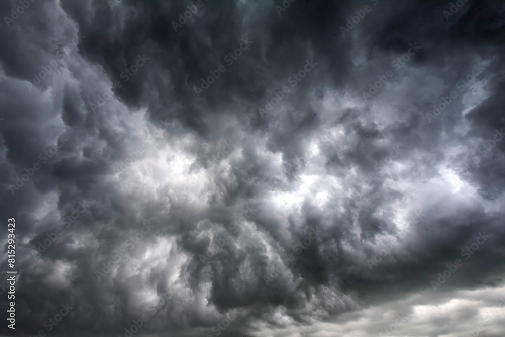 Fototapeta premium Dramatic dark storm rain clouds black sky background. Dark thunderstorm clouds rainny atmosphere. Meteorology danger windstorm disasters climate. Dark cloudscape storm disaster gloomy gray cloud sky