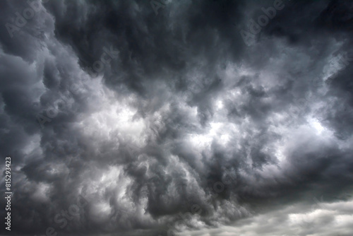 Fototapeta Naklejka Na Ścianę i Meble -  Dramatic dark storm rain clouds black sky background. Dark thunderstorm clouds rainny atmosphere. Meteorology danger windstorm disasters climate. Dark cloudscape storm disaster gloomy gray cloud sky