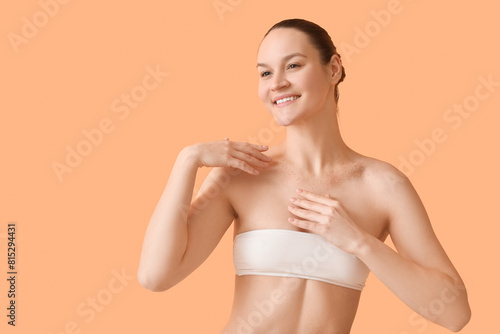 Happy young woman applying ...