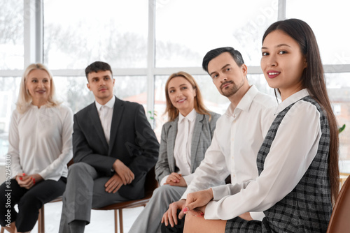 Asian business woman smiling at group therapy session  closeup