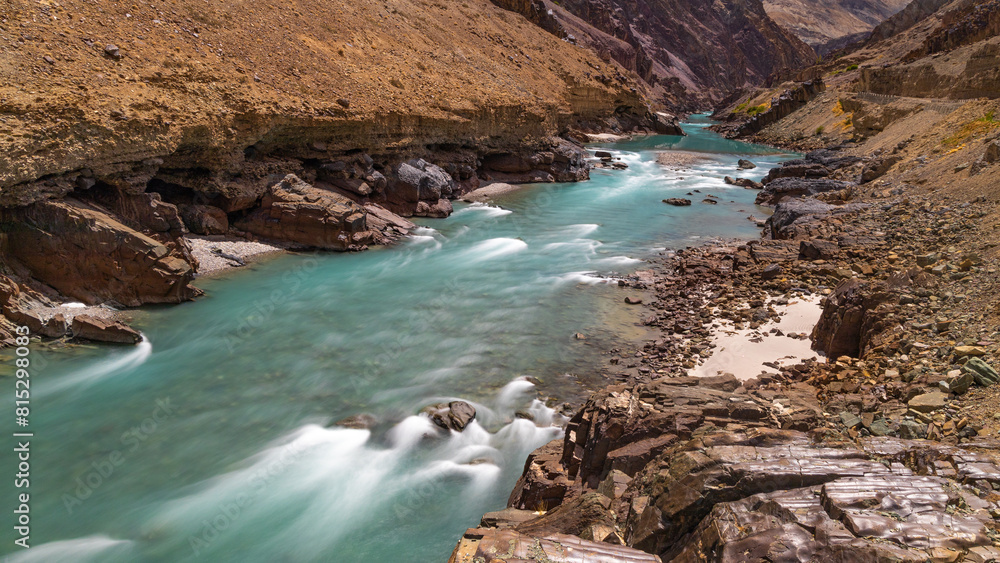 A closeup view of long exposure of clear green water flowing over rocks A closeup view of long exposure of clear green water flowing over rocks