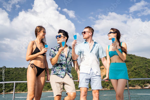Group of diverse friends drink champagne while having a party in yacht.  © Kawee