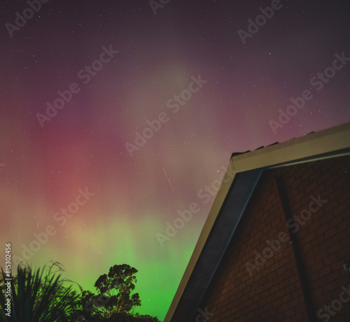 aurora australis or southern lights visible from Tasmania's clear night sky full of stars and constellations, shot in May 2024