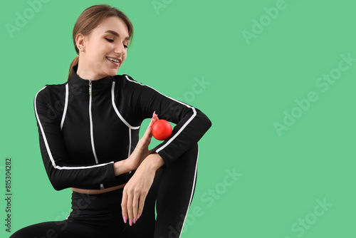 Sporty young woman massagin...
