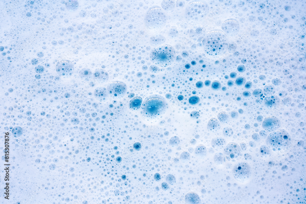 Detergent foam bubble on water. Blue background, Soap sud Detergent foam bubble on water. Blue background, Soap sud