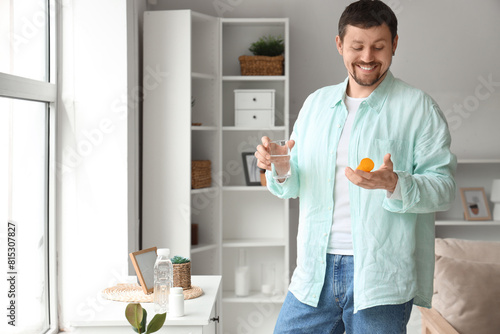 Young man with glass of wat...