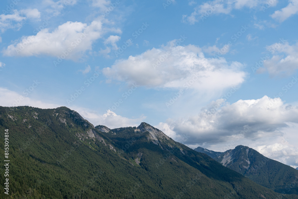 blue sky and clouds over mountain range in Canada blue sky and clouds over mountain range in Canada