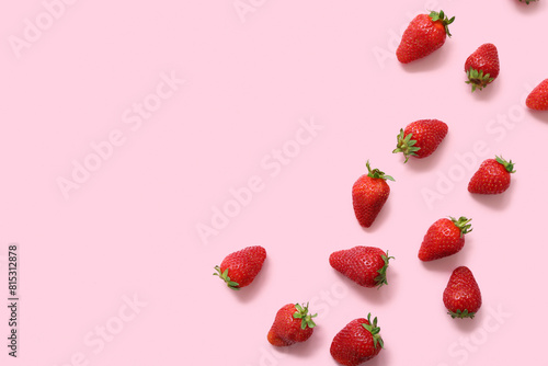 Sweet fresh strawberries on pink background photo