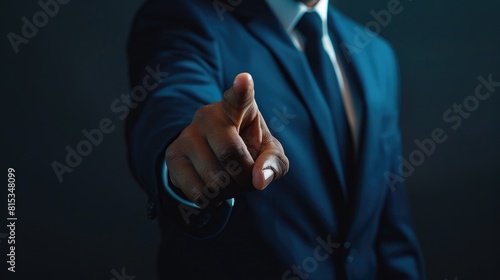 Dramatic close-up of a businessman's hand pointing directly at the viewer, set against a dark, moody background