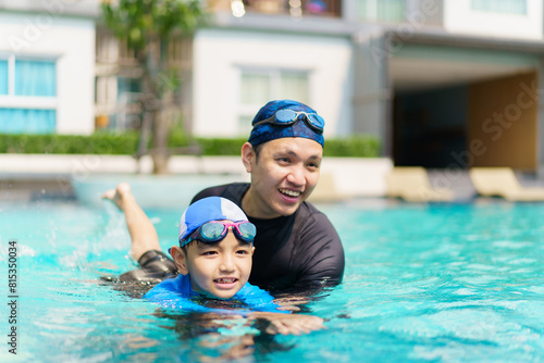 Lovely Asian father and son enjoy swimming together.