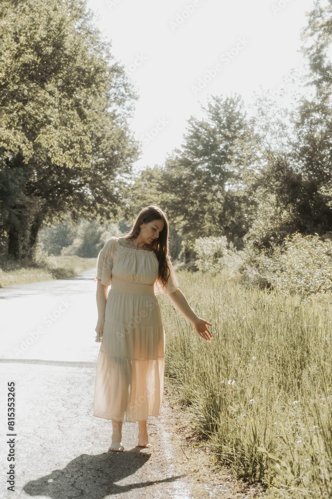 Woman outdoors walking on the road on a hot summer day Woman outdoors walking on the road on a hot summer day