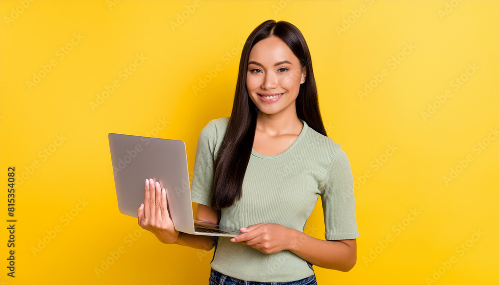 Successful young woman student freelancer using laptop, watching webinars, working remotely, e-learning e-commerce online isolated in yellow background Successful young woman student freelancer using laptop, watching webinars, working remotely, e-learning e-commerce online isolated in yellow background