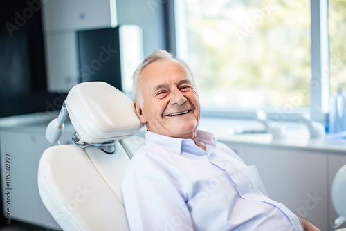 Close-up photo of a smiling man sitting in a chair in a dental office. He is waiting for the dentist for an oral procedure. Teeth whitening concept.