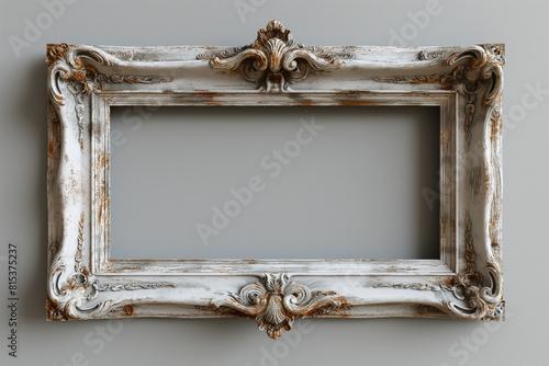 ornate shabby chic picture frame with flourishes over a gray background photo