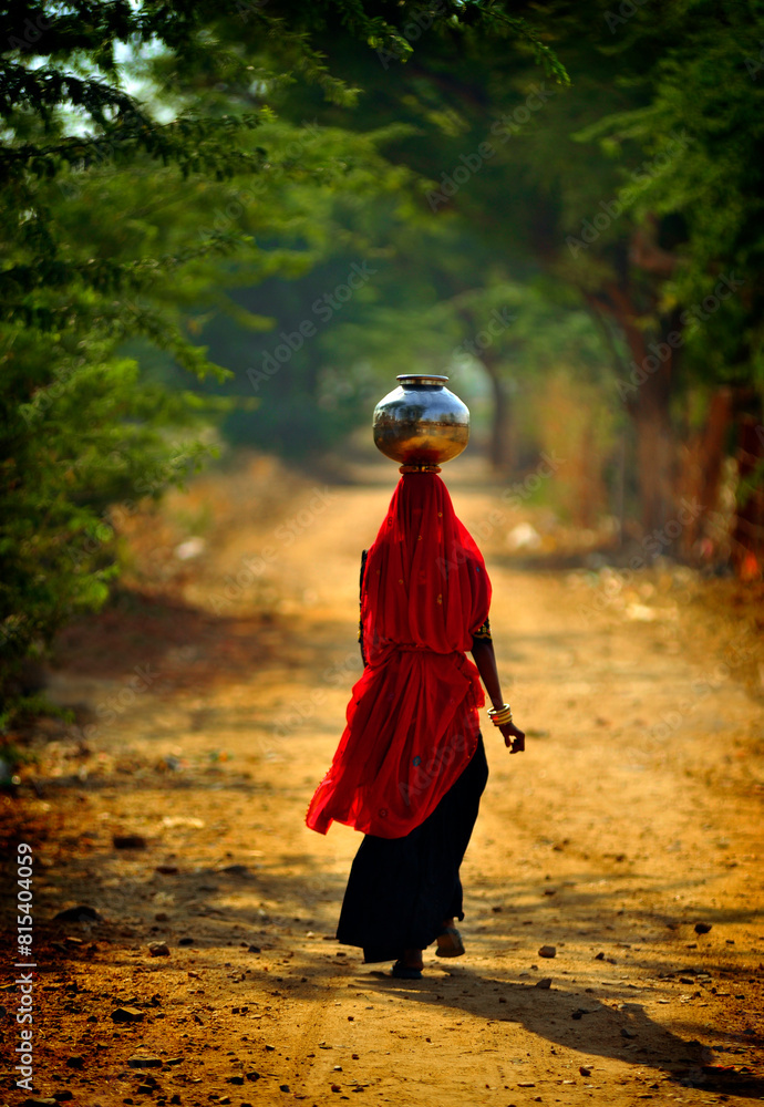 Indian woman carrying vase on head, India Indian woman carrying vase on head, India