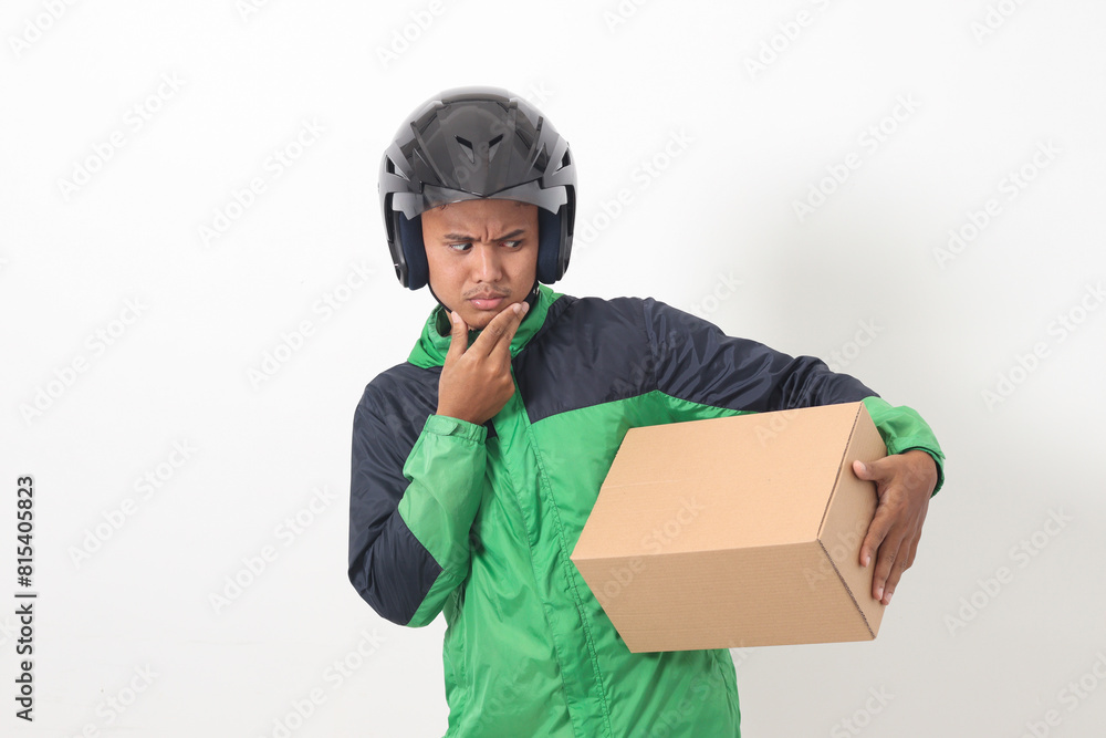 Portrait of Asian online courier driver wearing green jacket and helmet delivering package and box for customer. Isolated image on white background Portrait of Asian online courier driver wearing green jacket and helmet delivering package and box for customer. Isolated image on white background