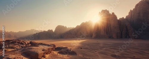 Sun over a vast desert with sand dunes and dramatic mountain structures, portraying tranquility and the grandeur of nature