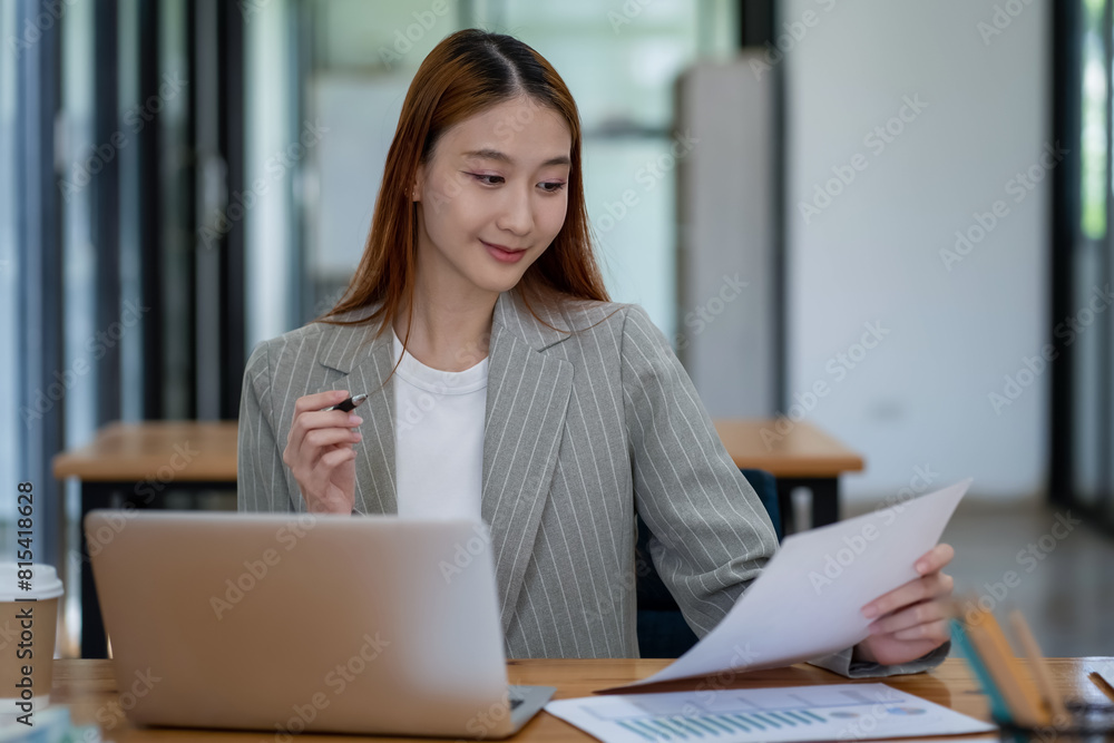 Asian business woman working In office using laptop and tablet, business concept Asian business woman working In office using laptop and tablet, business concept