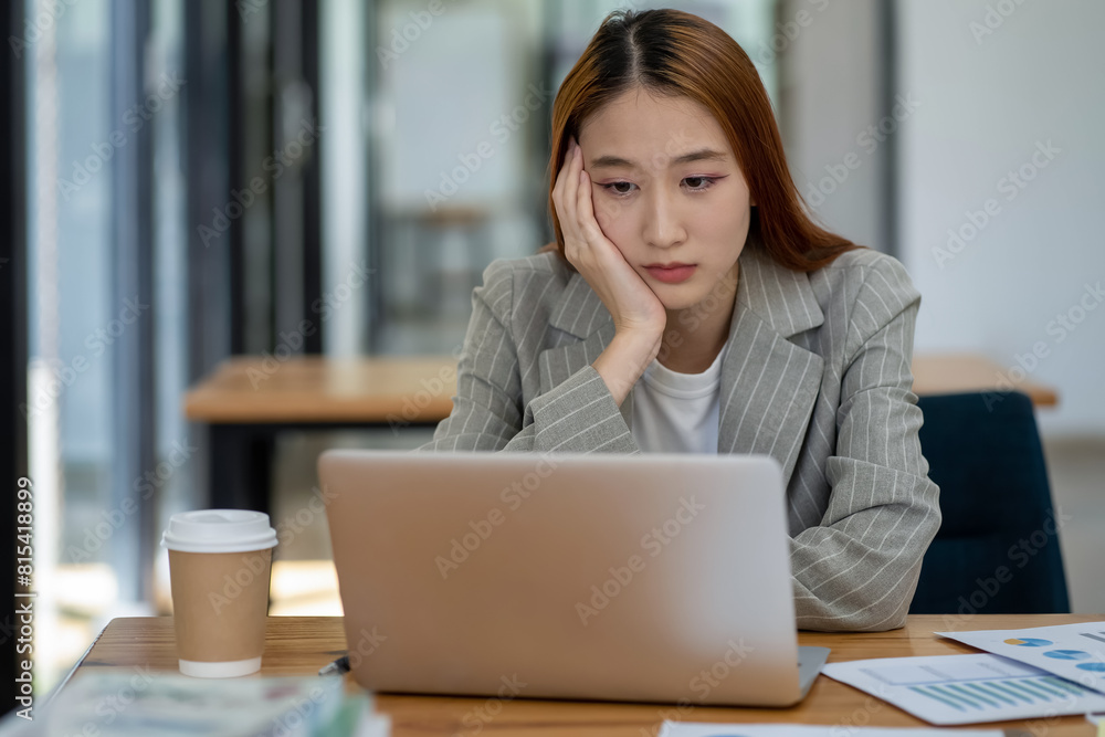 Asian businesswoman is tired and stressed in the office. Business concept. Asian businesswoman is tired and stressed in the office. Business concept.