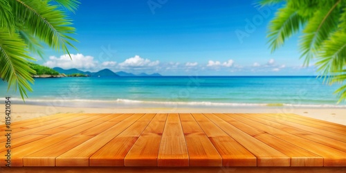 Empty orange bamboo table top stands for display product against the defocused white sand beach surrounded with coconut trees and sea background on a sunny day with blue sky.