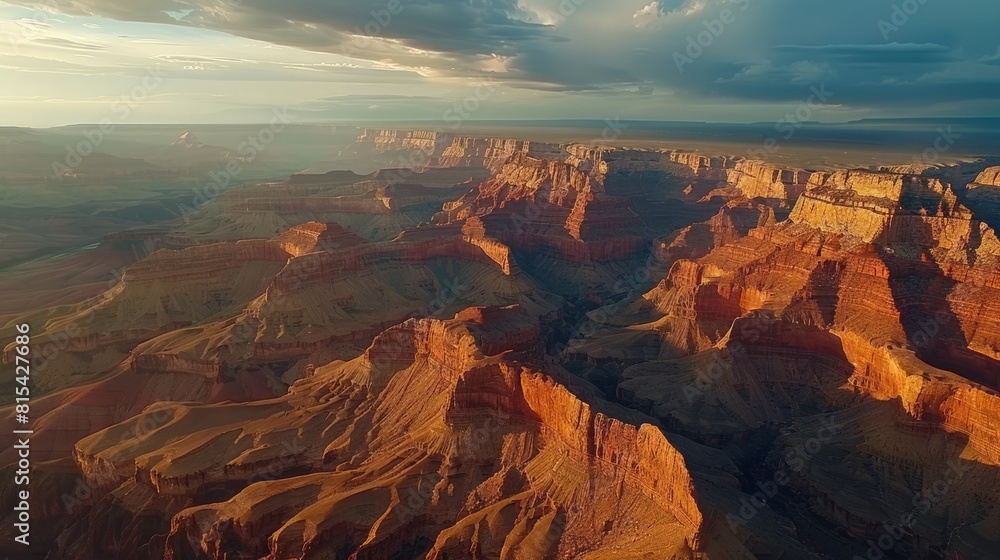 Aerial view of the Grand Canyon in the United States, showcasing its vast and rugged landscape with layers of red rock formations stretching into the horizon.     